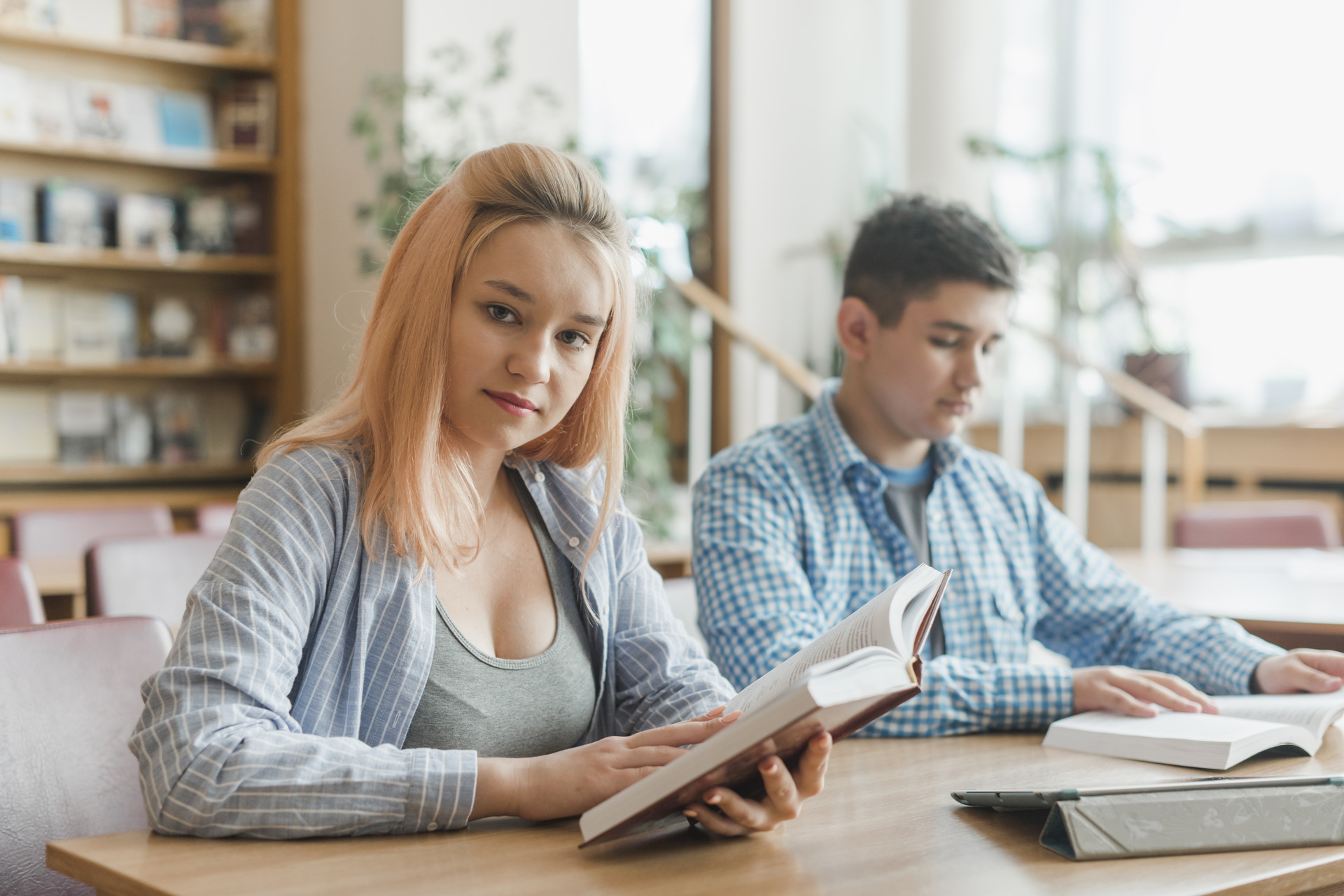 female-teenager-with-book-near-friend(1)